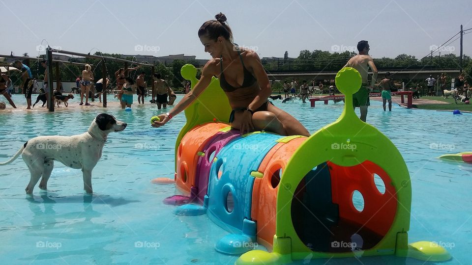 Woman giving ball to dog in resort