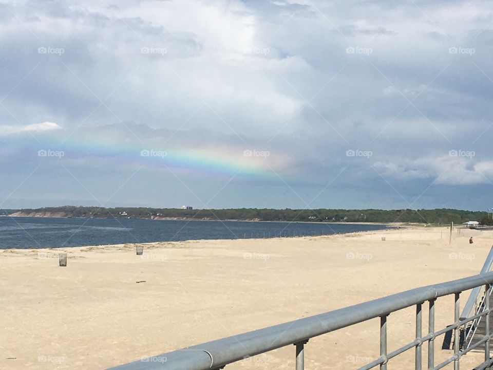 A Rainbow at the beach after a rain storm.