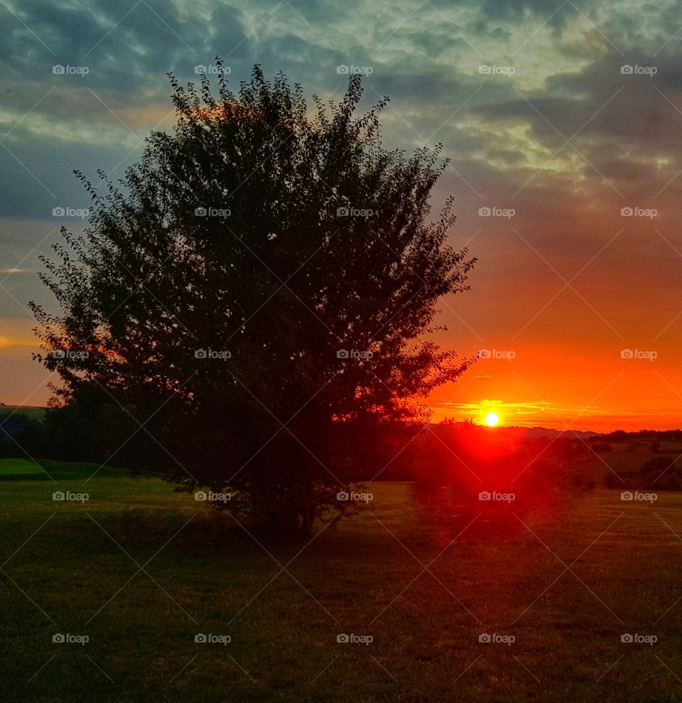 when the sun just lies on the mountian's