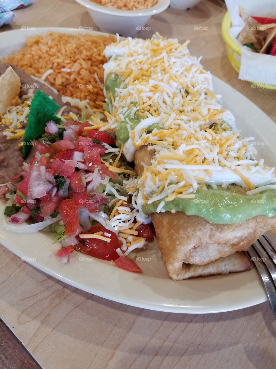 Chicken chimichanga with rice and beans.