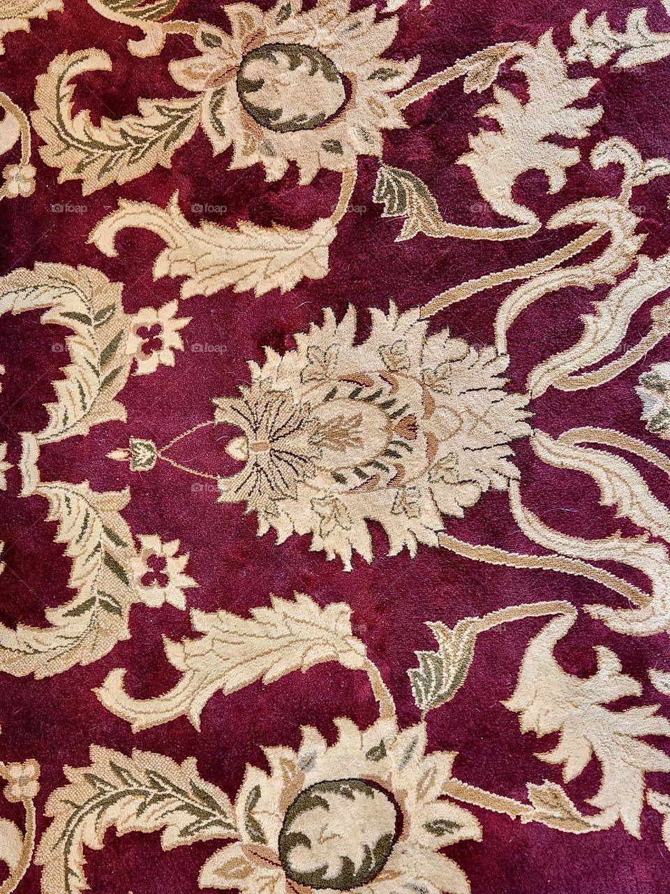 close up view of a burgundy floor rug with an ornate leafy pattern at an outdoor sporting goods store in Oregon