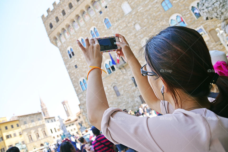 a woman taking a picture with the smartphone