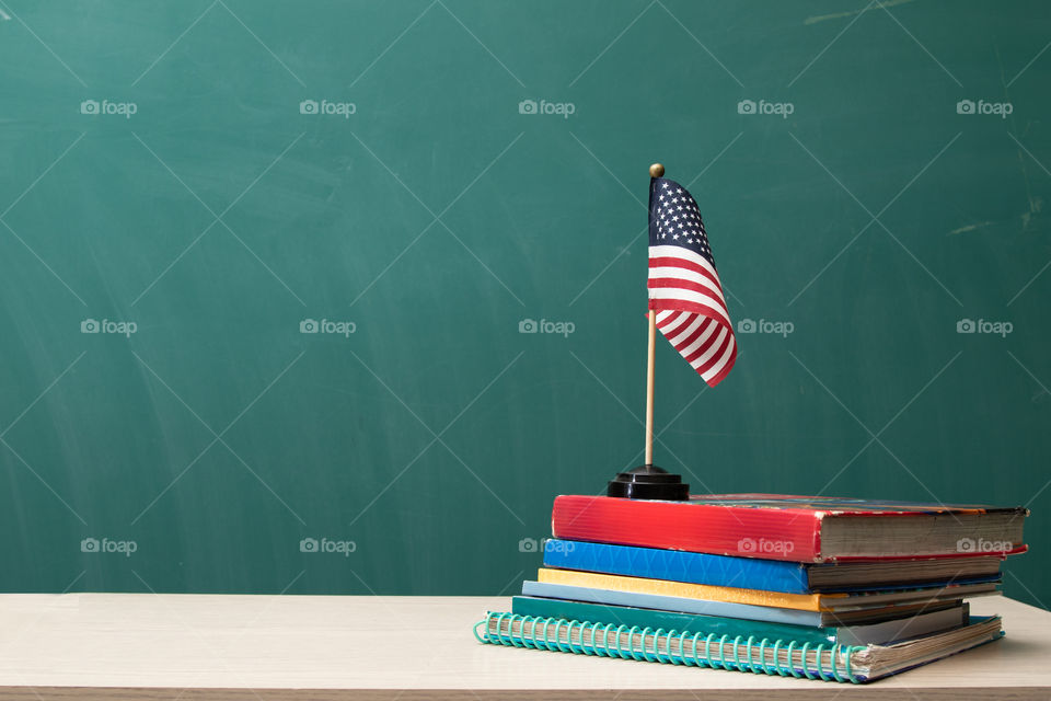 American Flag, books,desk and  chalkboard.