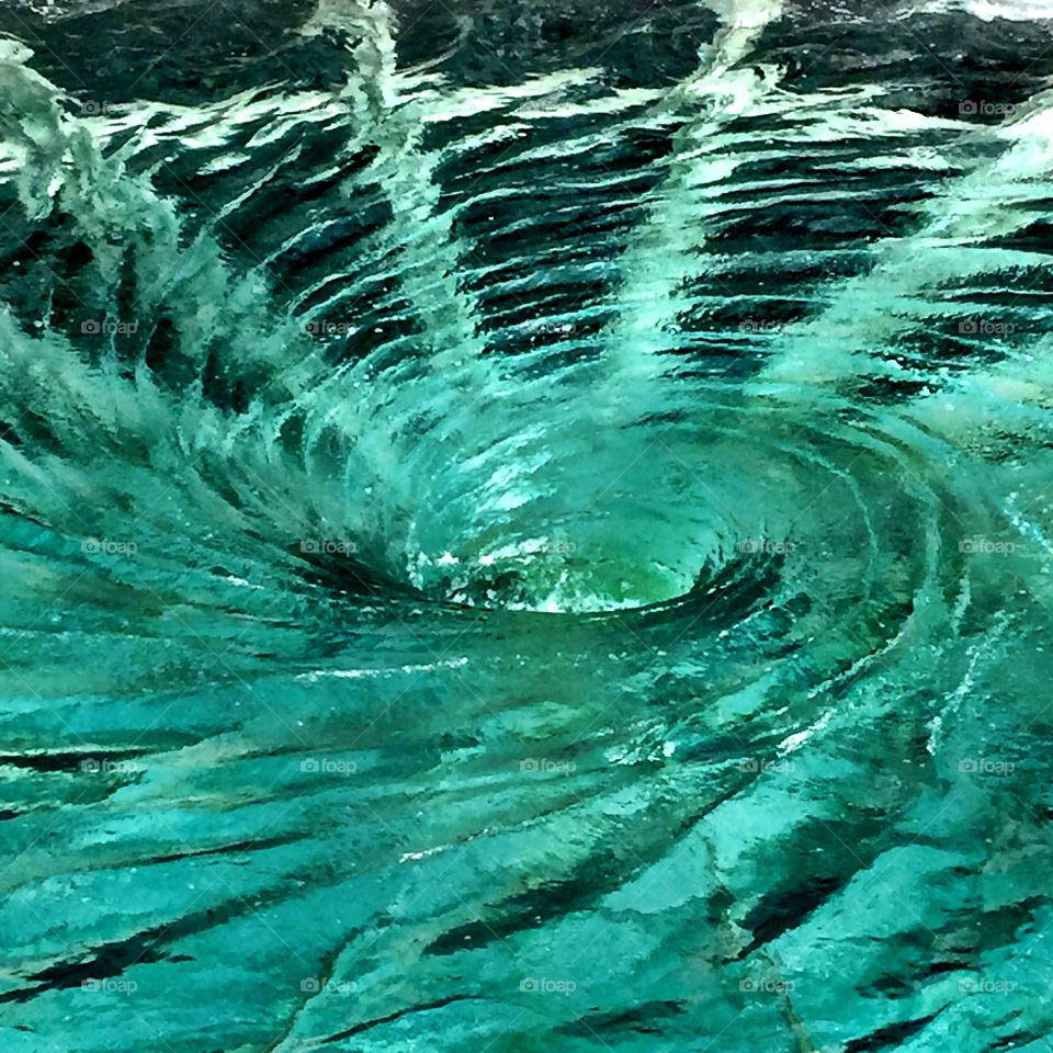 Pool of swirling water with spines like web of a spider 