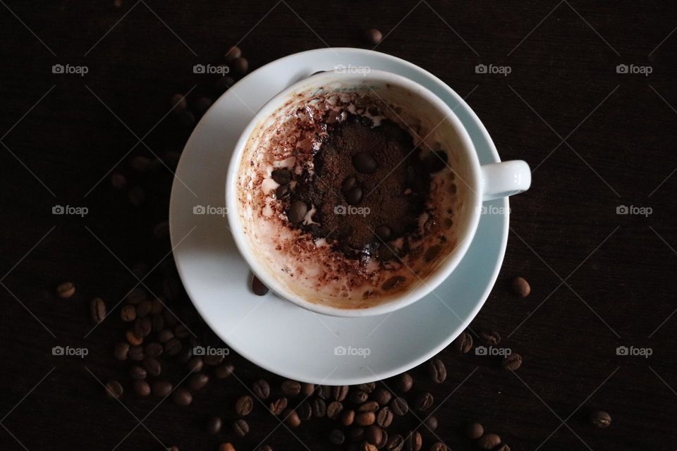 A cup of coffee and coffee beans