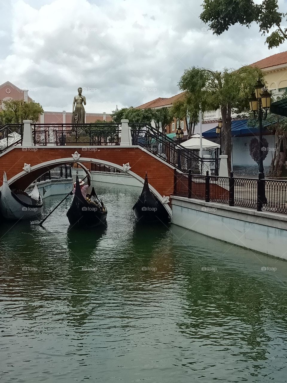 A gondola passing a bridge