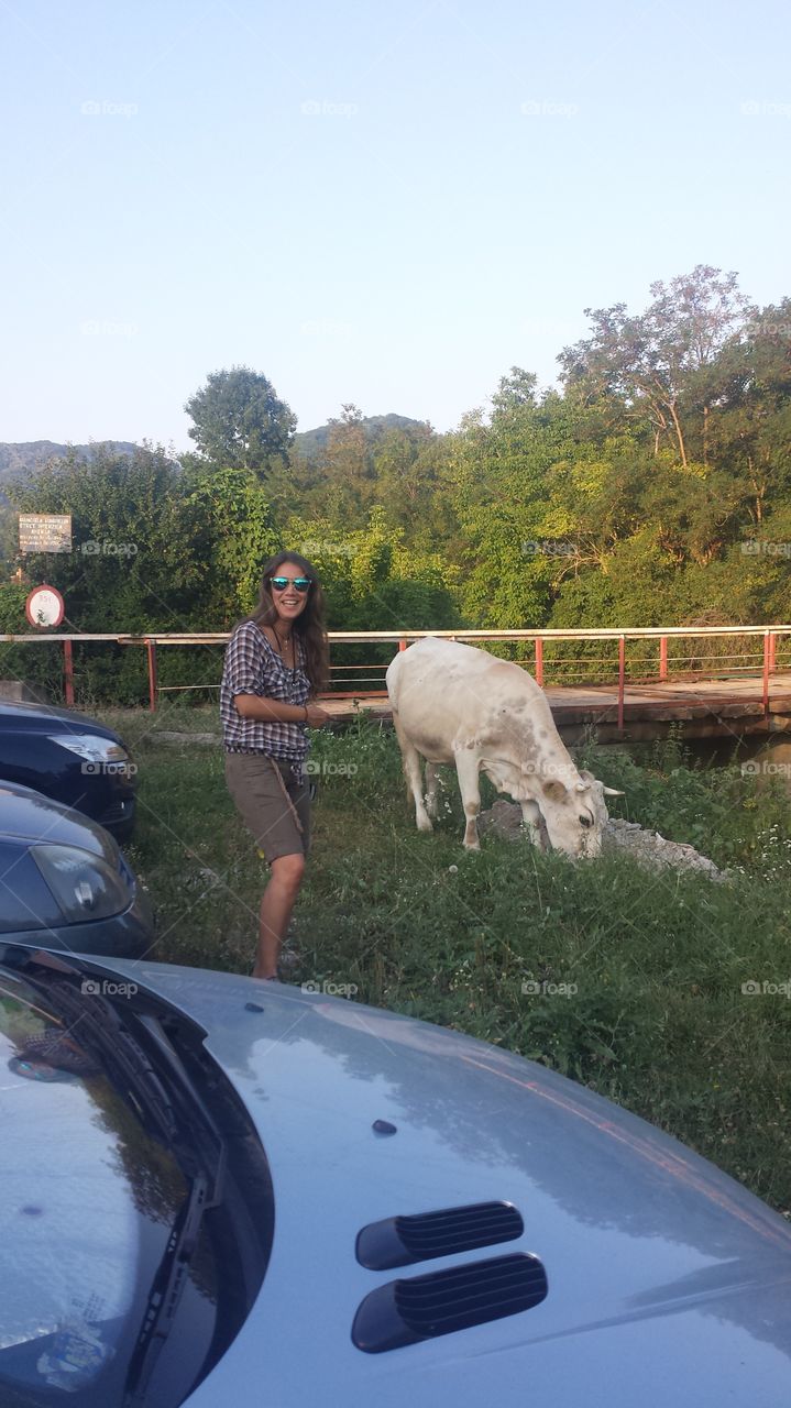 Woman standing near the cow