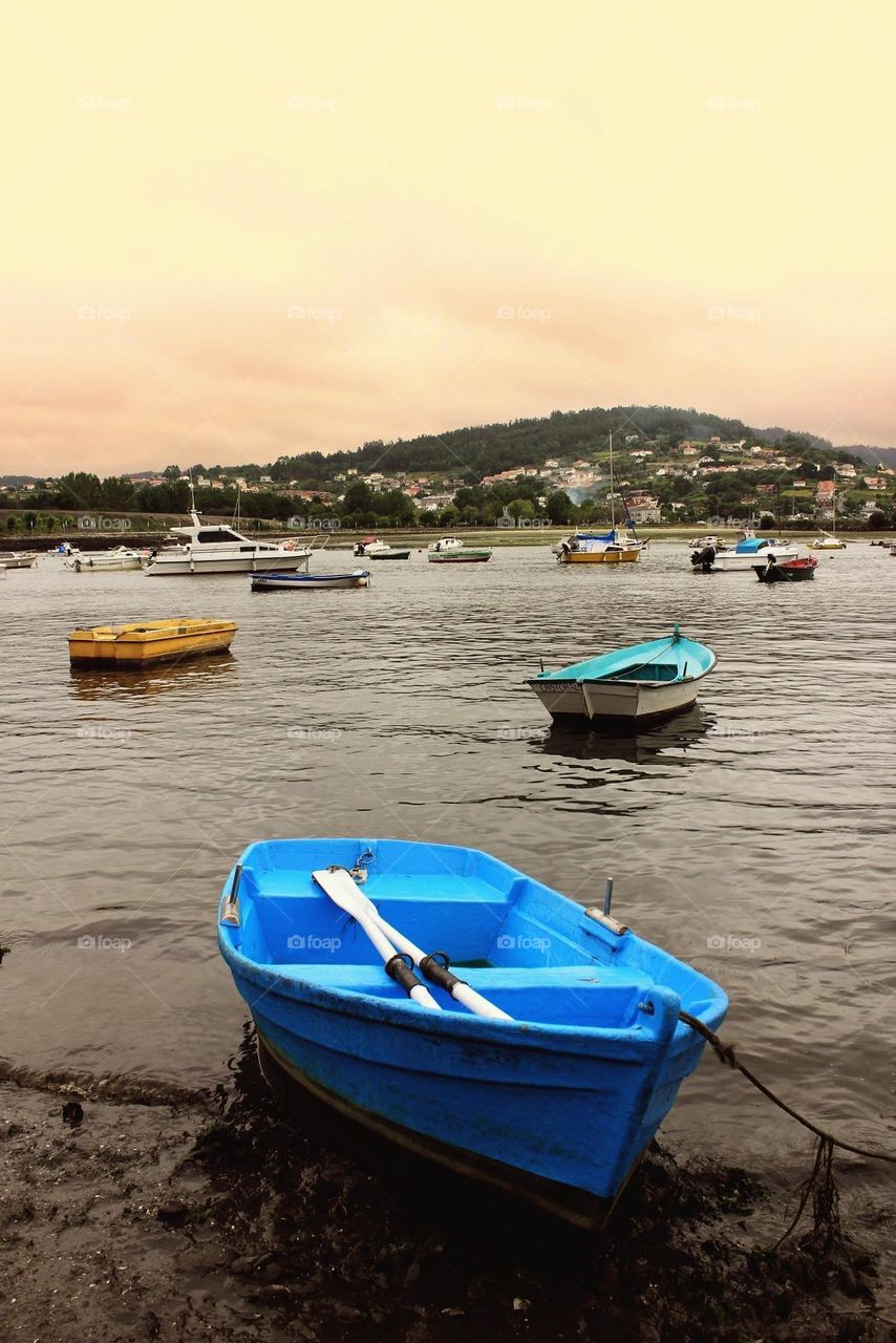 Small fishing boats moored nearby the coast. Galicia, Spain.