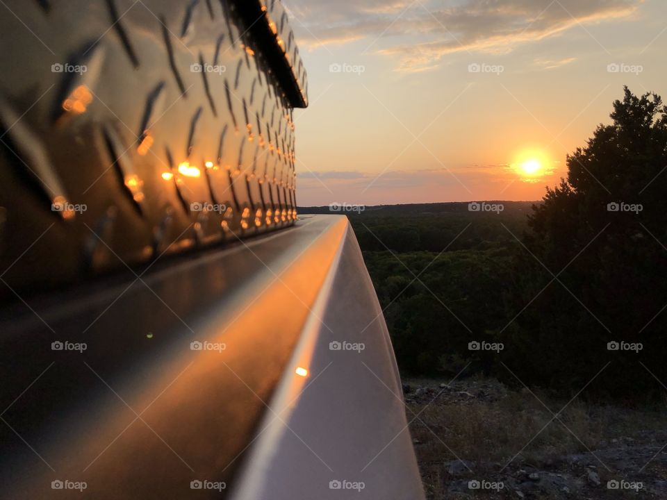 Sunset from the view of a pickup in the country 