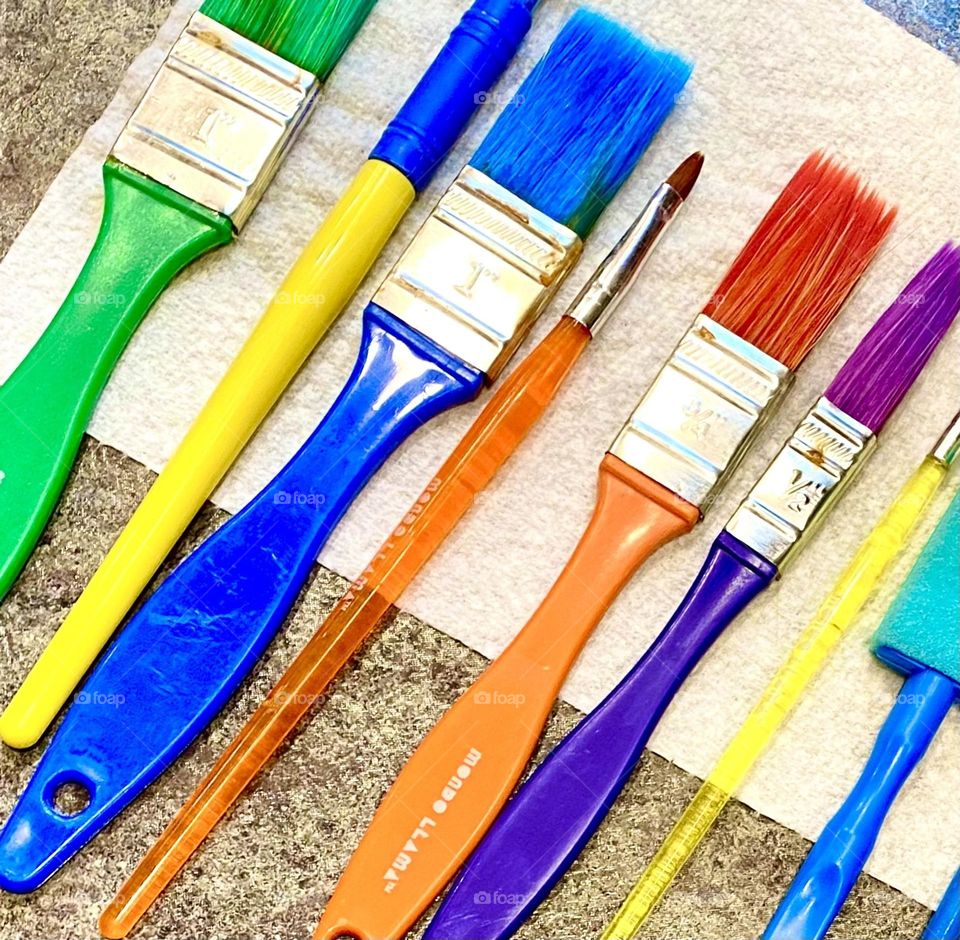 Colorful paint brushes in a row