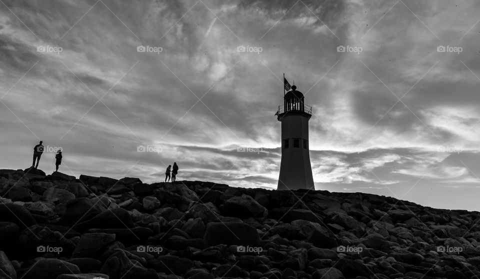 Black and white light house with clouds 