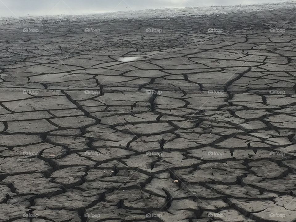 Large expanse of dry cracked earth as the result of drought