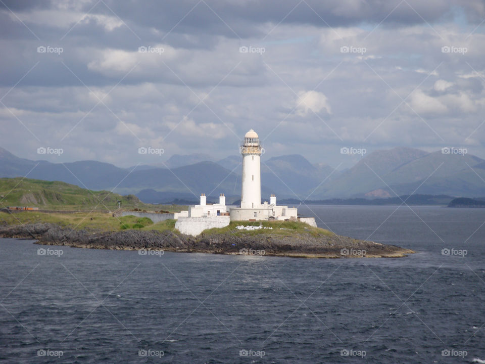 Lighthouse in cloudy sky