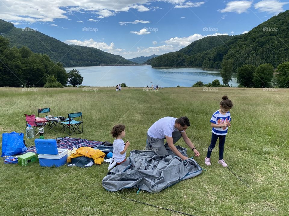 A lake, a tent and happy family