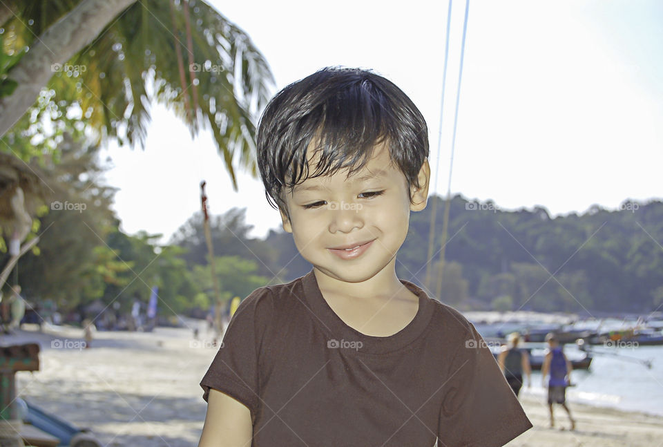 Portrait boy Sitting on the beach, Koh Lipe at Satun in Thailand.