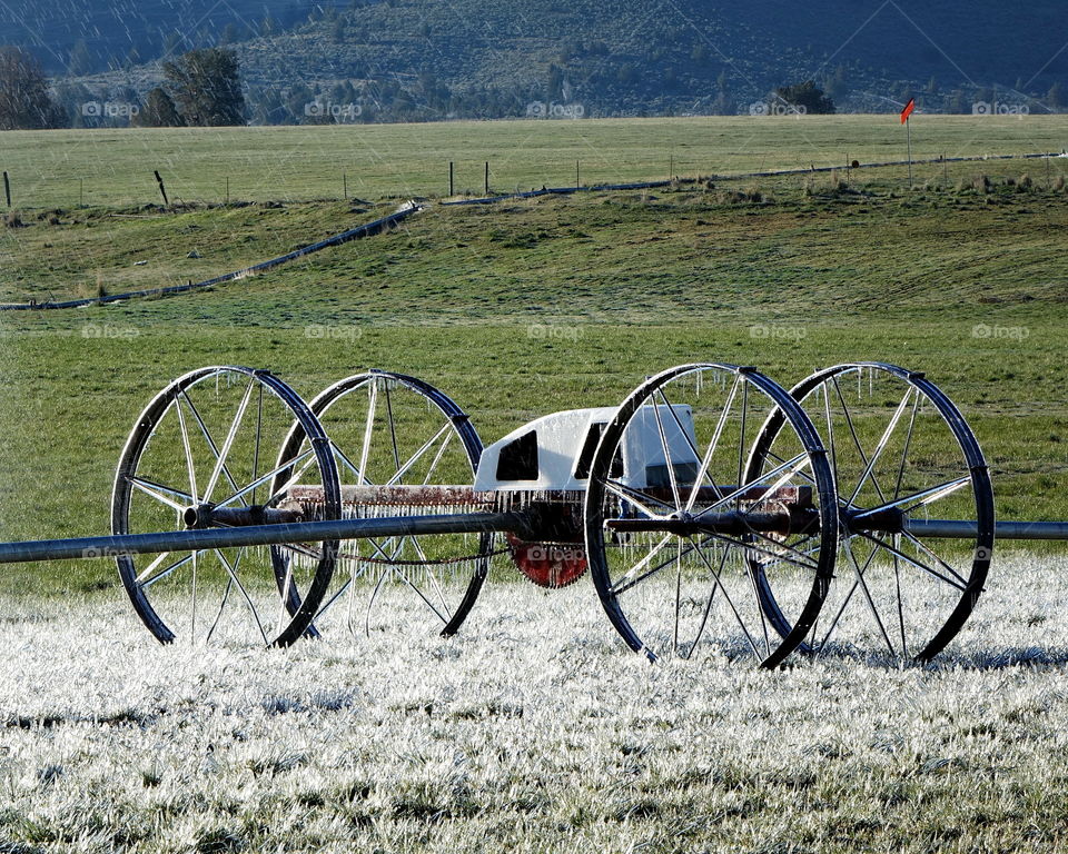 A field wheel line drive motor covered in ice as the sun rises in Central Oregon. 