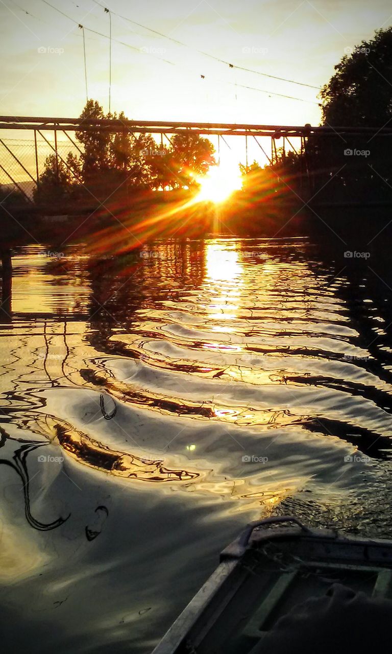 watch the ripples in the water reflect the setting sun