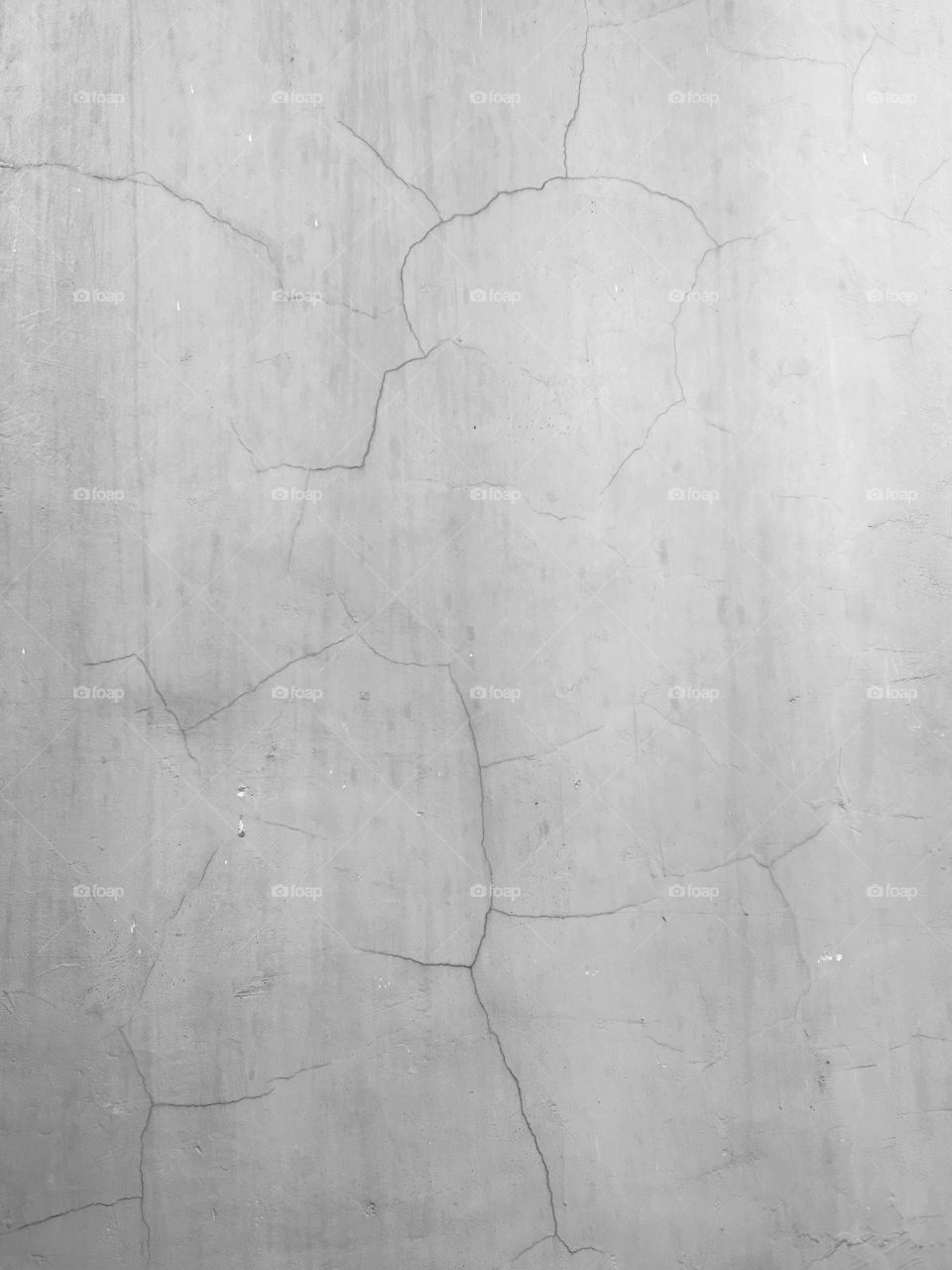 Concrete wall with scratches and cracks in surface