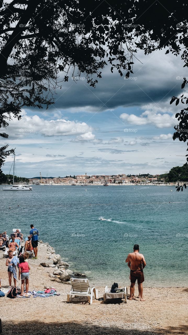 Tourists sunbathe on a beach in Rovinj, Croatia