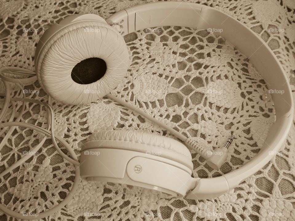 beautiful headphones on antique embroidered fabric