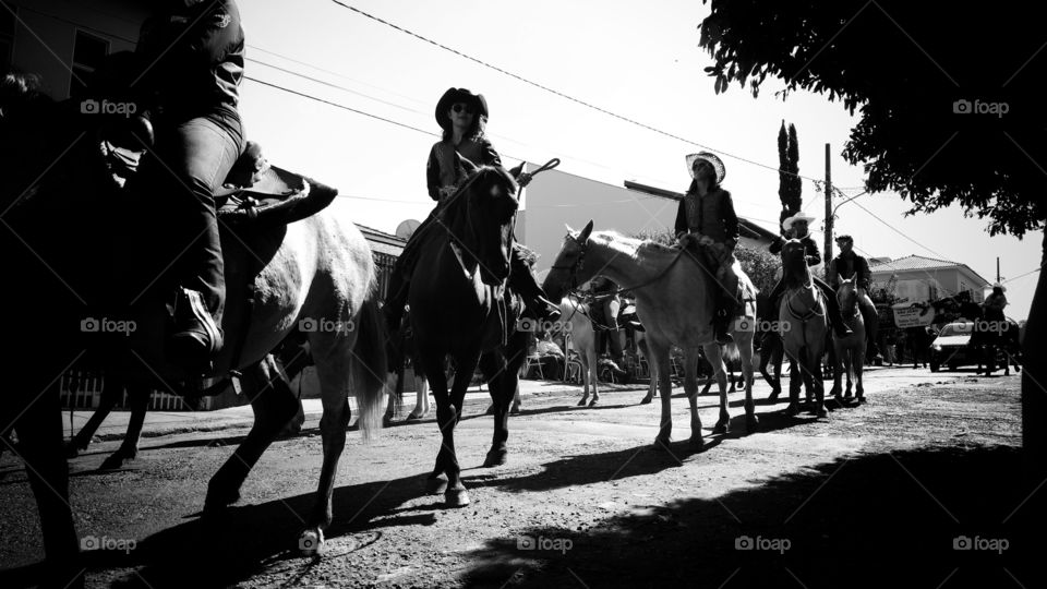 Confraternização, cavalgada nas ruas. Homens e mulheres.  Desfile de tropas,  boiadas e veículos.
