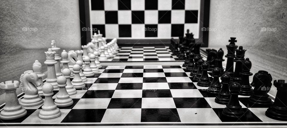 Chess games.  Boards and game pieces.  black and white multiverse