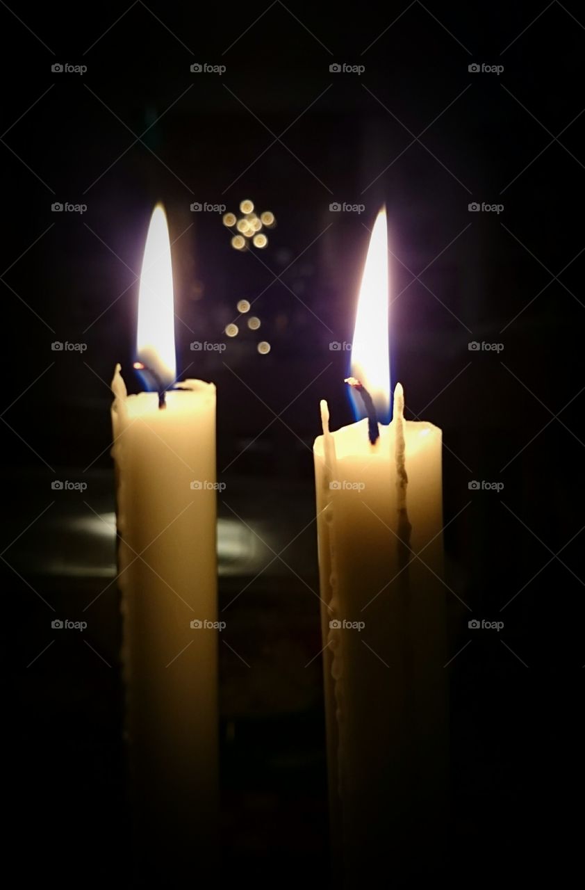 Lit candles in darkroom