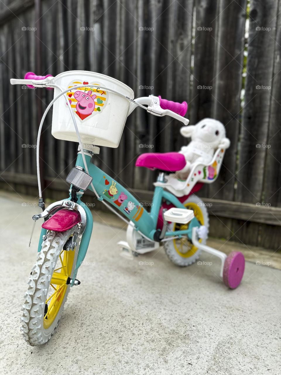 A small bicycle awaits its owner's return from kindergarten.