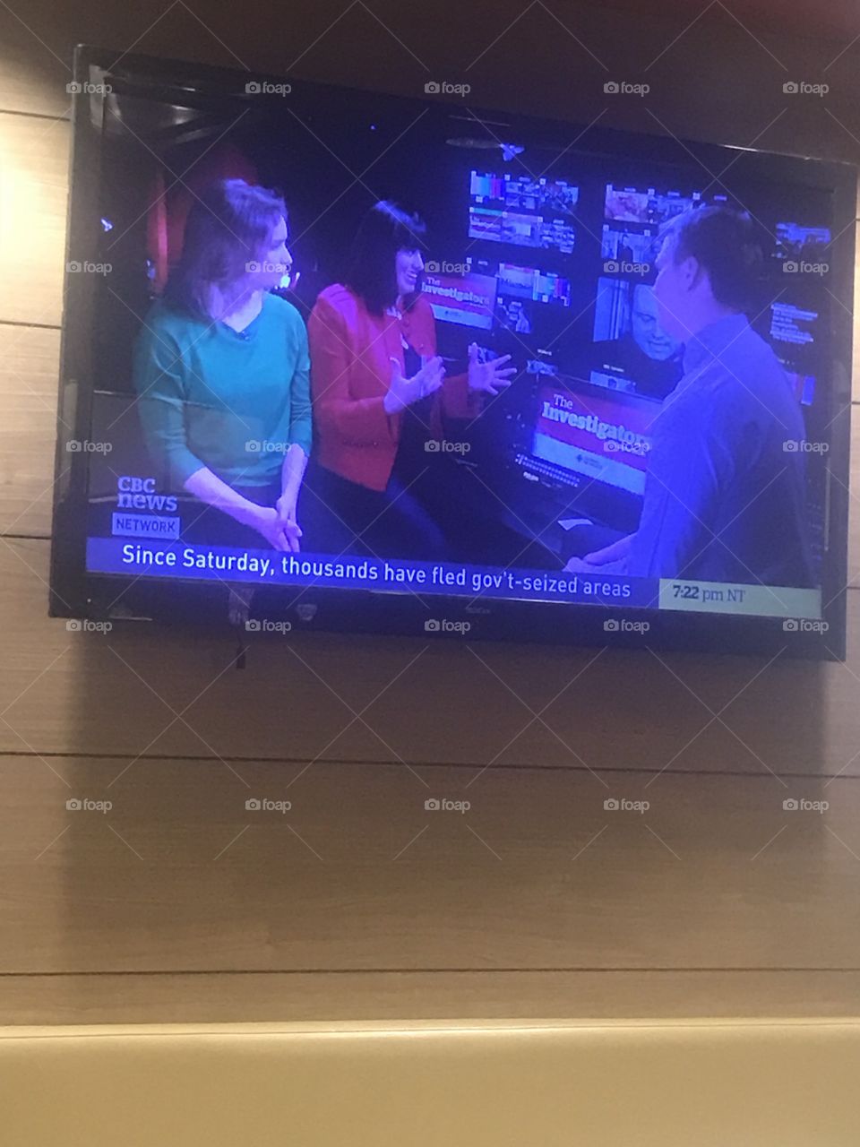 Photo of a CBC news network interview, and a headline about the Syrian civil war. It’s a great action shot of what CBC journalism re the fifth estate looks like. But also the investigators. Great TV journalism action shot, as seen on a restaurant TV