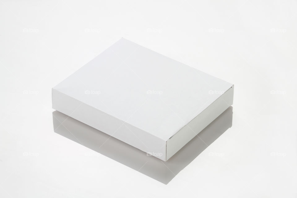 White colored blank box on white reflective background