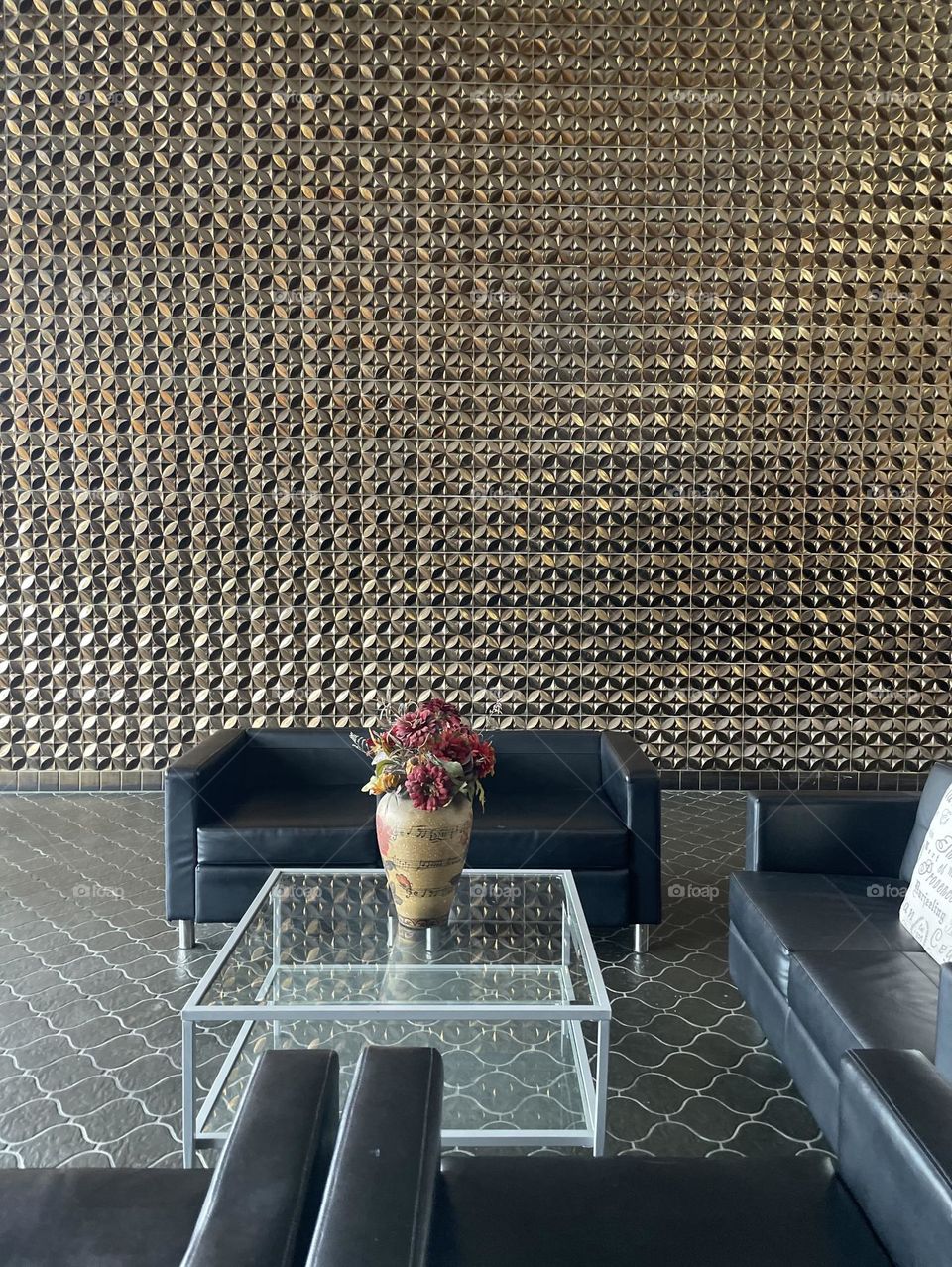 Entranceway to a business building, entering the foyer of a building, shiny metallic walls in a building, waiting area of a building 