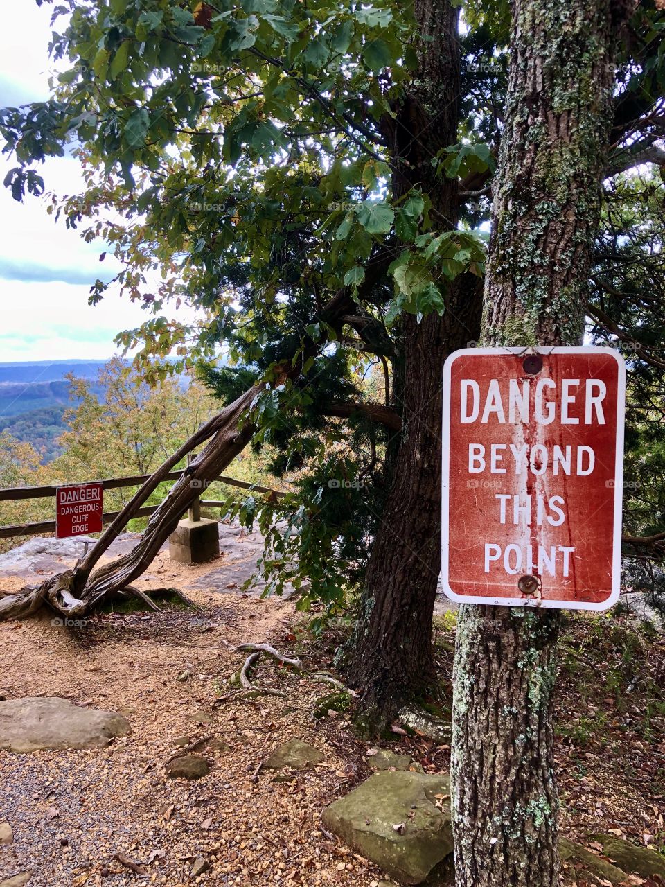 Warning signs near scenic cliff