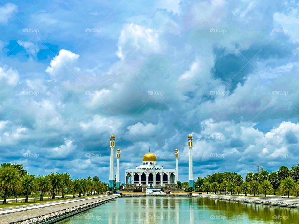 Mosque architecture view from front and a large pond at the front of the mosque 