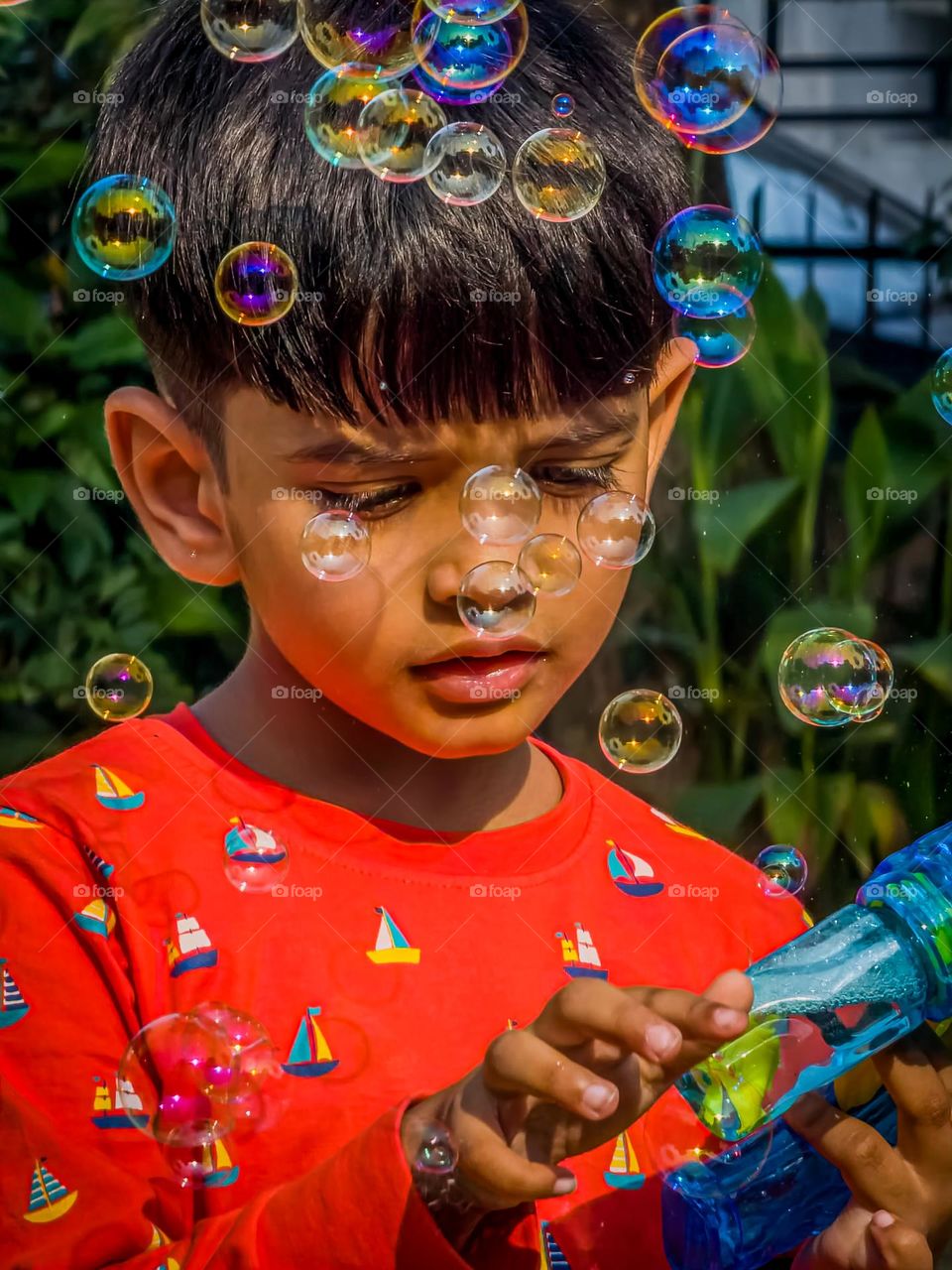 Kid playing with bubble gun