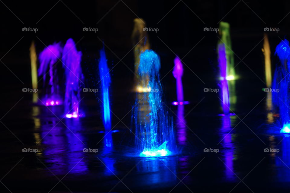 Color fountain reflecting on water