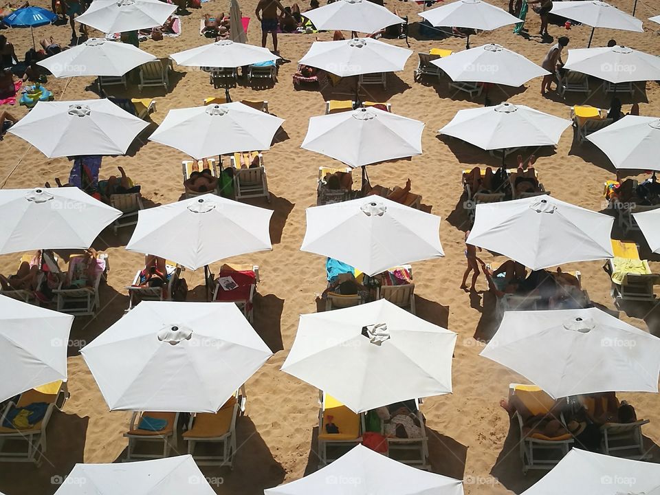 White umbrellas in a beach.