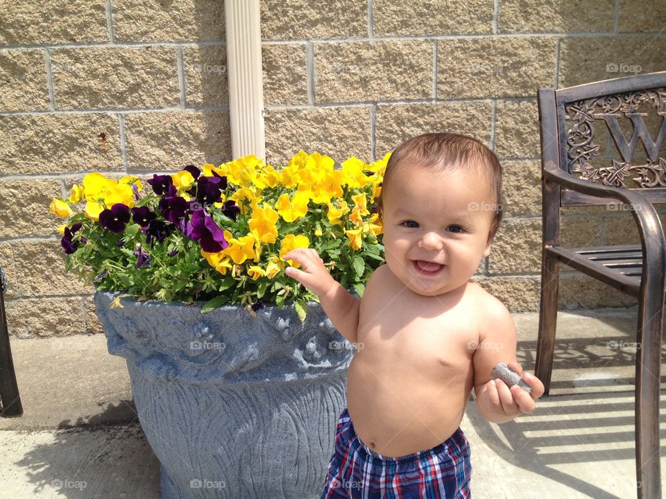 Baby flowers . Baby by flower pot