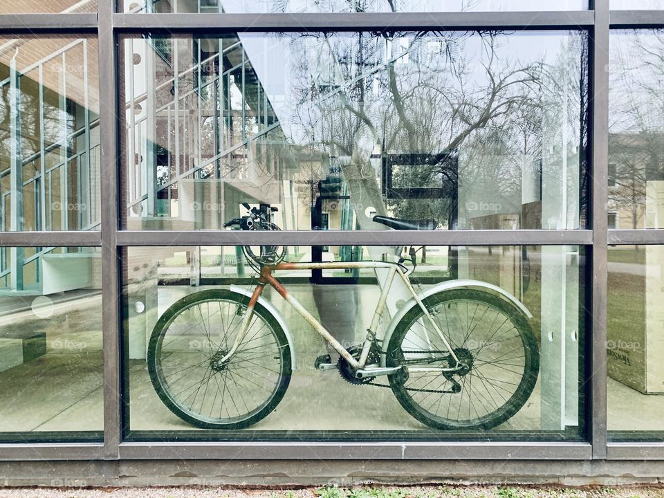 in an architectural structure restored for public use, a bicycle leaning against the window can be glimpsed inside