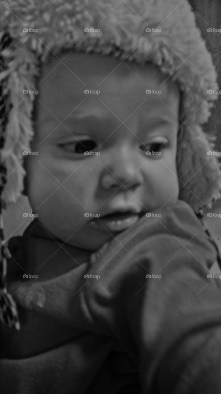 baby with winter hat on in black and white