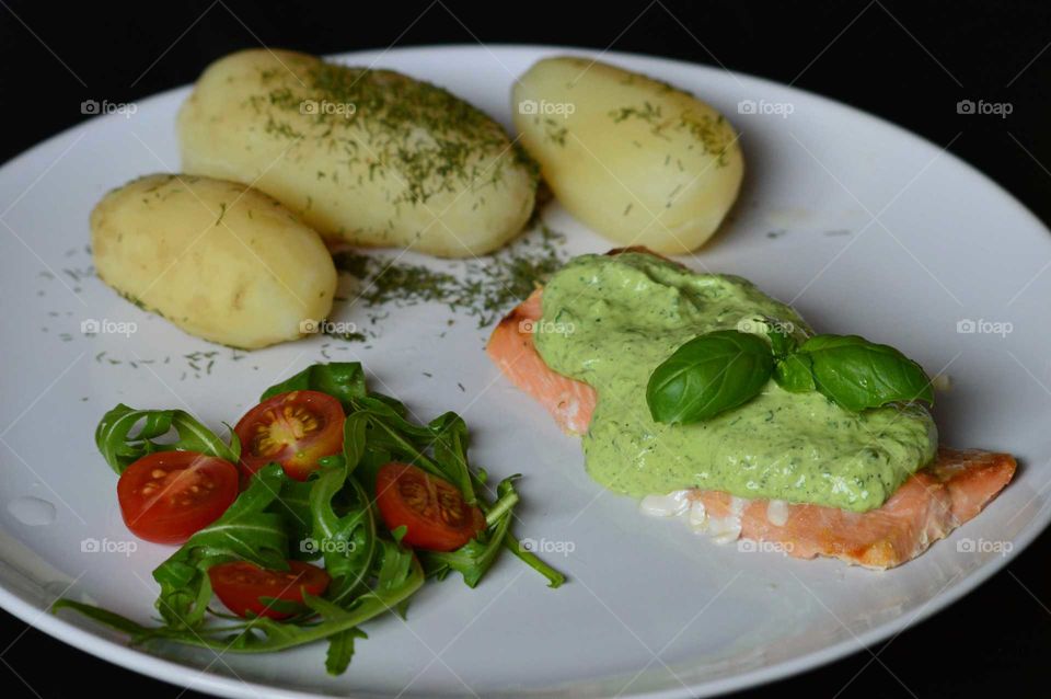 salmon with basil sauce and fresh salad