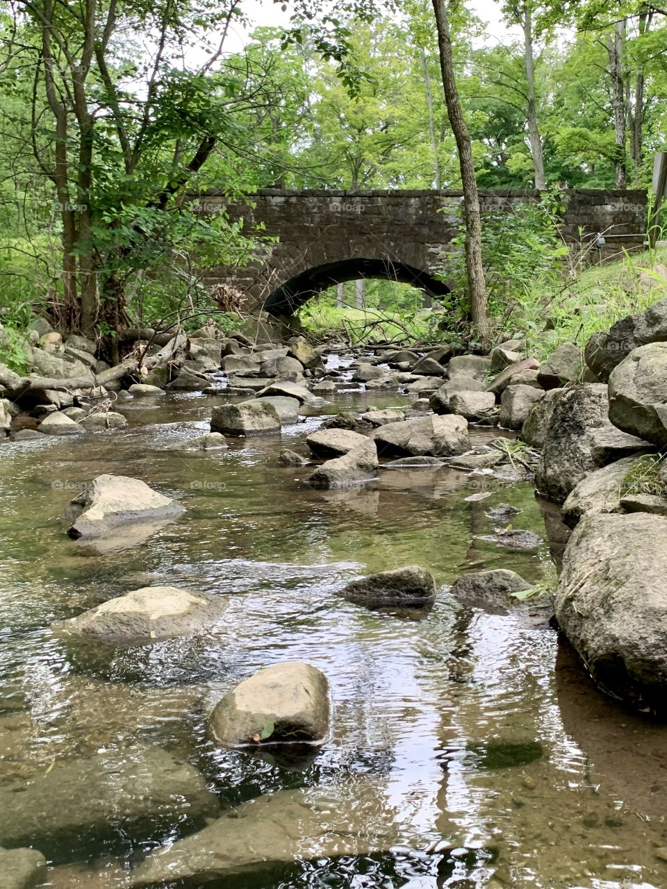 Stone bridge and a small stream with some rocks