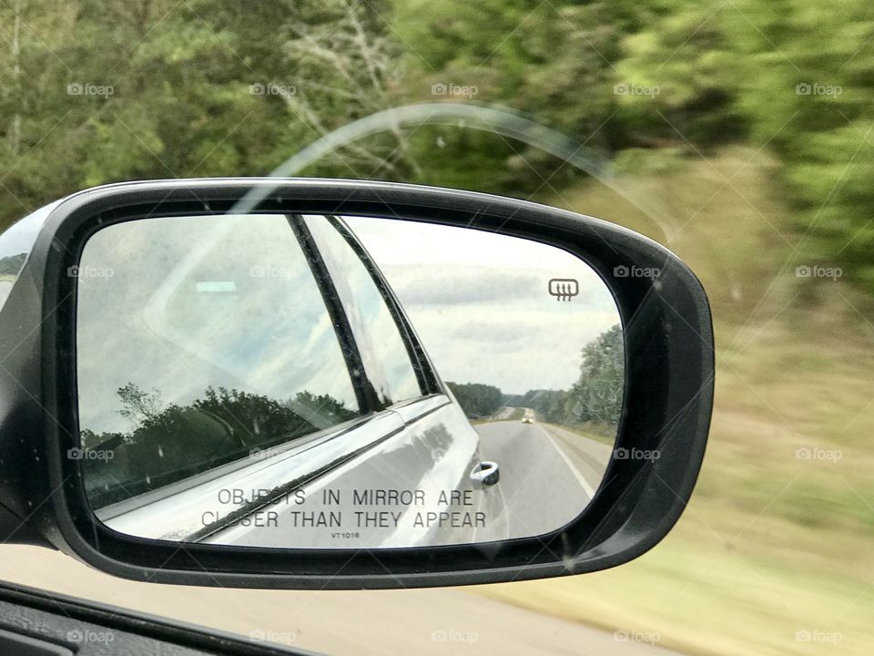 Looking in the side view mirror