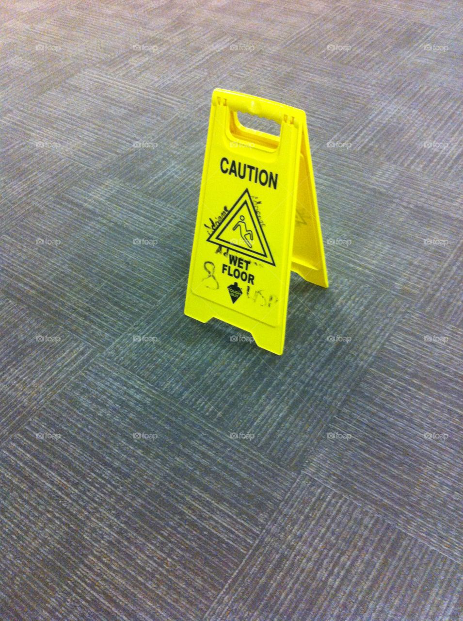 Wet floor sign on carpet