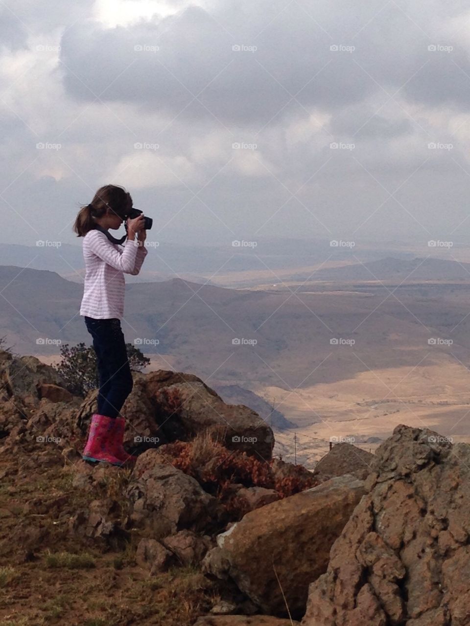 Girl taking picture of Drakensberg
