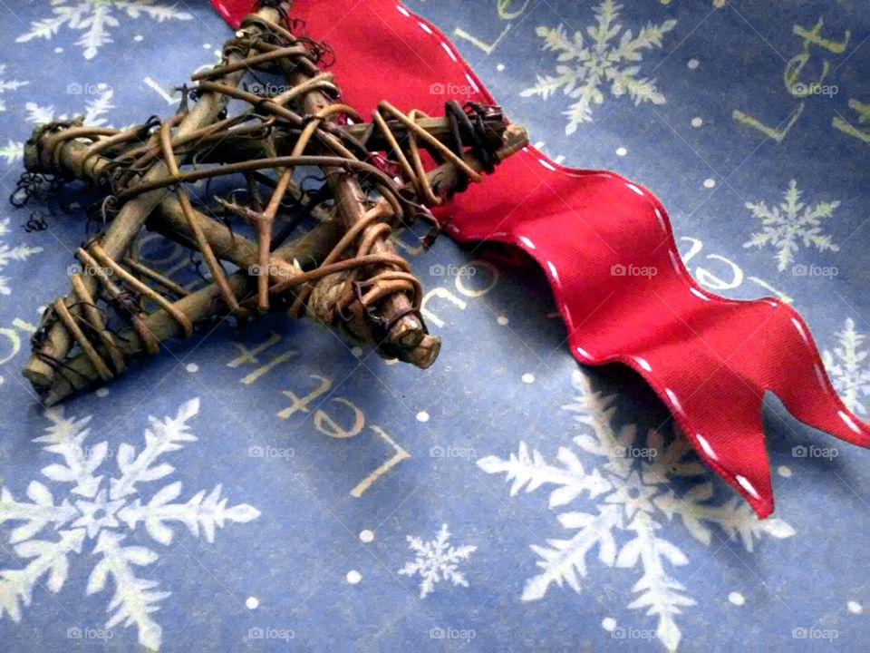 Star made with stick with red ribbon