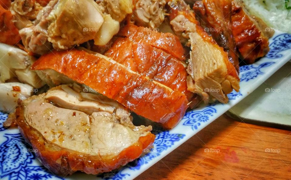 Cantonese roast duck, presented on a plate in bite-size pieces. The duck has a shinning red-brownish skin and is frequently seen hanging behind shop windows.