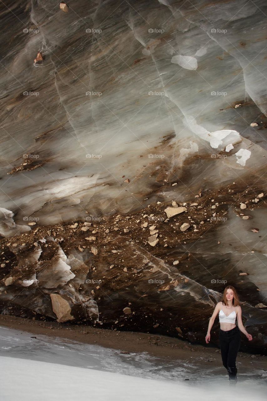 Girl in a top posing against an ice wall