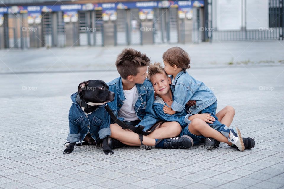 walking the dog down the street, the owner walks the weakling, teaches her, cleans up after her, educates, plays with his pet. people and dogs are best friends