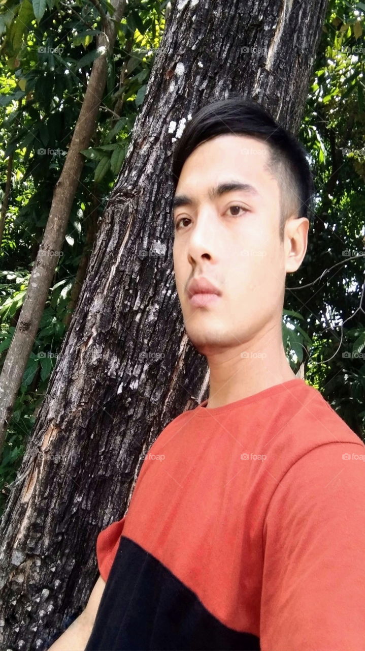 Stylish in front of a tree..ask for voice on my mission.