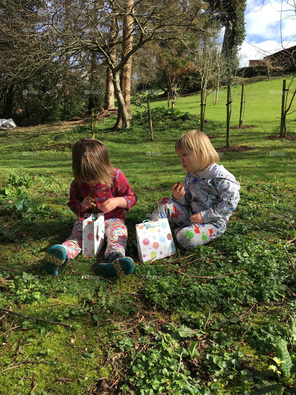 Two children enjoying their Easter eggs after a fun Easter Egg hunt in the garden. Well done boys 